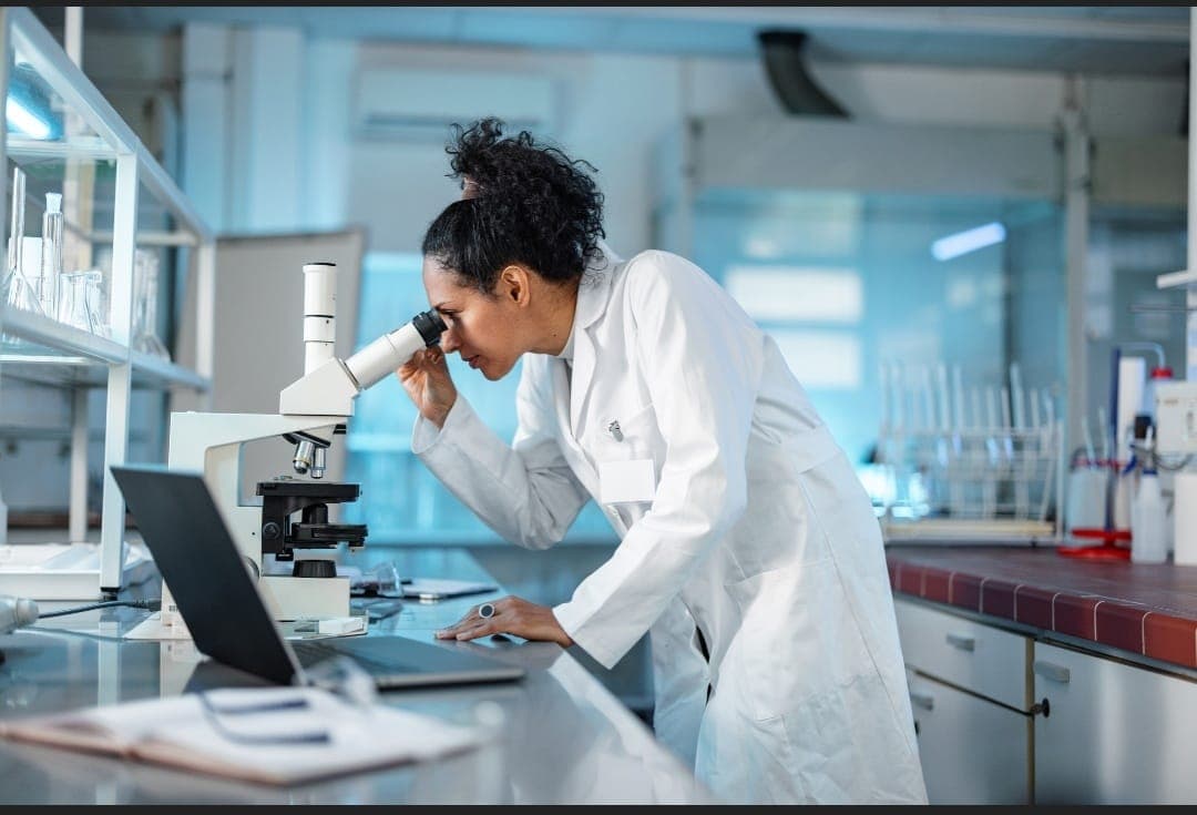 Research scientist examining samples under a laboratory microscope